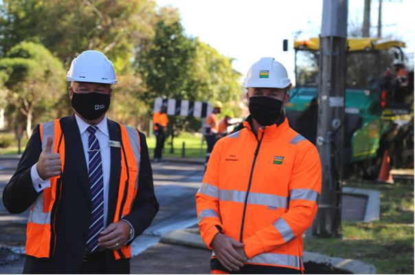 two men in uniform with black mask and white safety helmet
